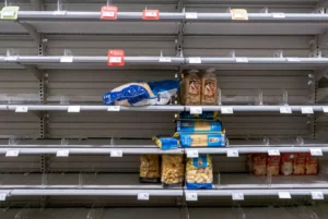 Vue sur des rayons presque vides de supermarché symbolisant la pénurie de crédit